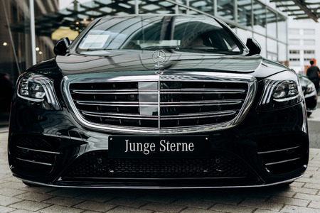 Berlin, August 29, 2018: Close-up of the front of the new luxury black Mercedes-Benz car. The inscription in German is translated as Young Stars.のeditorial素材