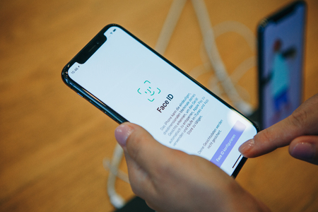 Berlin, August 29, 2018: The buyer looks to buy a new modern iPhone X with face detection technology or an face ID in the official Apple store in Berlin in Germany.のeditorial素材