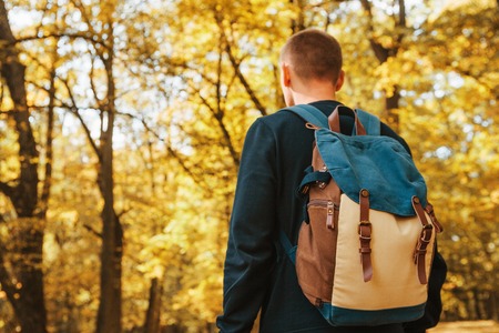 Tourist or traveler with a backpack in the autumn forest. Hikingの写真素材