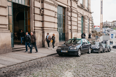 Portugal, Porto, 05 May 2018: Many taxi cars are waiting for customers near the railway station in Porto in Portugal. Service for the transport of people.のeditorial素材