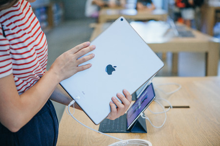 Berlin, August 29, 2018: The buyer chooses to buy a new iPad in the official store of Apple in Berlin.のeditorial素材