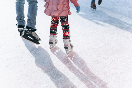 People ride on the skating rink on the ice rink during the Christmas holidays. Sports and fun pastime.の写真素材