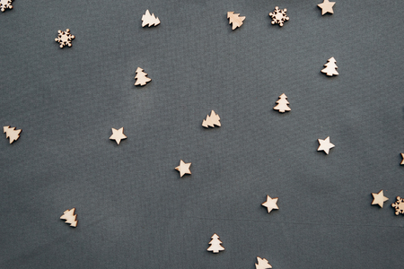 Small wooden Christmas trees and snowflakes. Festive decorated background. Christmas or New Years concept in a minimalist style.の写真素材