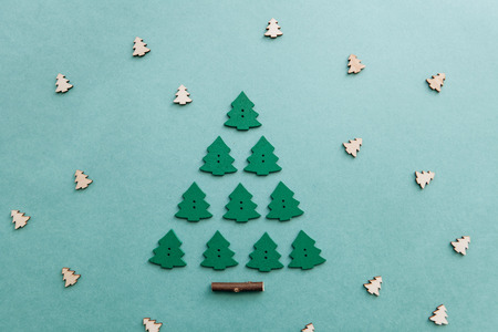 Creative idea in minimalistic style for Christmas or New Year themes. Christmas tree from other small wooden Christmas trees. Celebratory concept.の写真素材