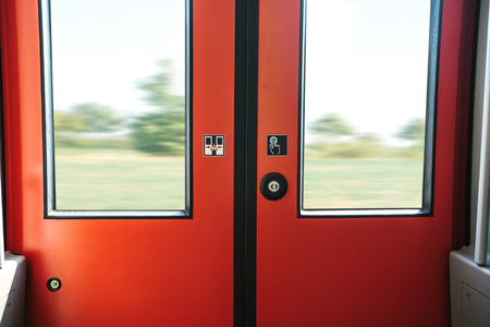 The exit door of the train with a button to automatically open the door on demand when the train...
