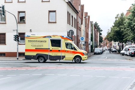 Germany, Muenster, October 5, 2018: An ambulance car moves along the city street to the patient.のeditorial素材