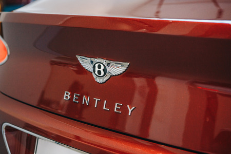 Berlin, August 29, 2018: Close up of a Bentley emblem on the back of a red car.