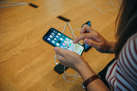 Berlin, August 29, 2018: The buyer looks to buy a new modern iPhone X in the official Apple store in Berlin in Germany.のeditorial素材