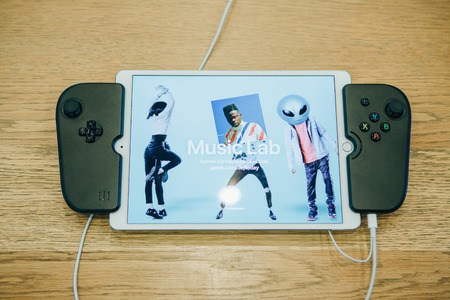 Berlin, August 29, 2018: Tablet ipad with special joysticks which turns into a console.のeditorial素材