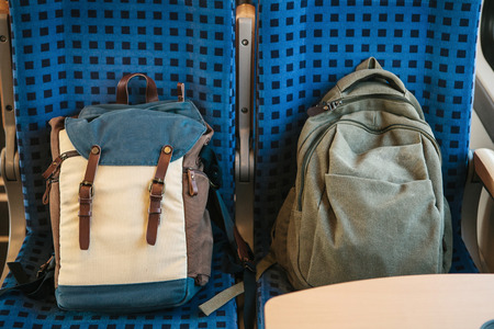 Tourist concept. Two backpacks on the seats in the train.の写真素材