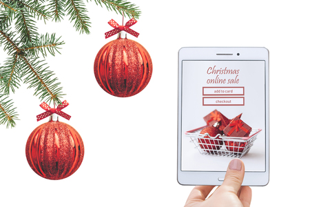 Christmas online sale. Tablet for buying gifts online on a white background.の写真素材