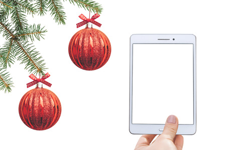 Christmas online sale. Tablet for buying gifts online. Tablet with an empty white screen on the background of Christmas decorations.の写真素材
