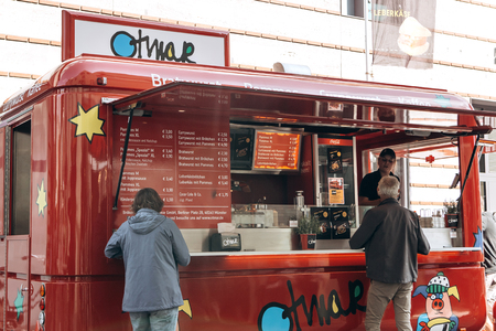 Germany, Muenster, October 5 2018: Sale of street food with a truck equipped for trade. Small business at the city fair.のeditorial素材