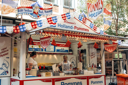 Germany, Muenster, October 5 2018: Street tent selling french fries. The inscription in German is translated Holland fries. Small business at the city fair.のeditorial素材