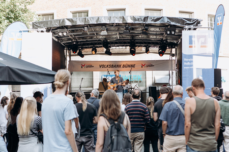 Germany, Muenster, October 5, 2018: Street rock concert on the main square of the city during the festive event. A crowd of people watching the concert and listening to music.のeditorial素材