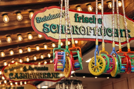 Germany, Muenster, October 5 2018: Street tent for the sale of sweets. The inscription in German translates fried chocolate fruit. Small business at the city fair.のeditorial素材