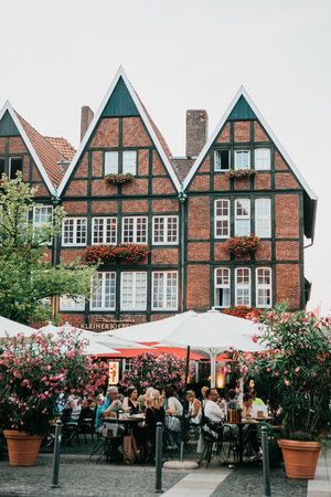 Germany, Muenster, September 25, 2018: Street Cafe. People eat drink and communicate with each otherのeditorial素材