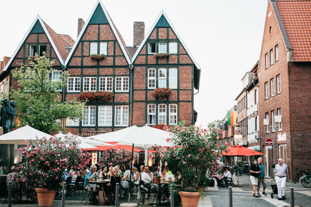 Germany, Muenster, September 25, 2018: Street Cafe. People eat drink and communicate with each otherのeditorial素材