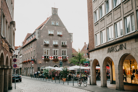 Germany, Muenster, September 25, 2018: Street Cafe. People eat drink and communicate with each otherのeditorial素材