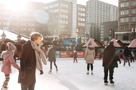 Berlin, December 25, 2017: People ride on an open skating rink on Alexanderplatz in Berlin in Germany during the Christmas holidays. Sports and fun pastime.のeditorial素材