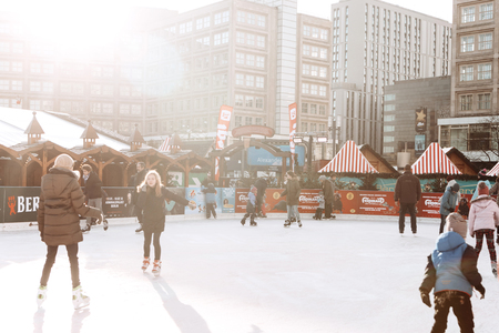 Berlin, December 25, 2017: People ride on an open skating rink on Alexanderplatz in Berlin in Germany during the Christmas holidays. Sports and fun pastime.のeditorial素材