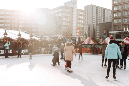 Berlin, December 25, 2017: People ride on an open skating rink on Alexanderplatz in Berlin in Germany during the Christmas holidays. Sports and fun pastime.のeditorial素材