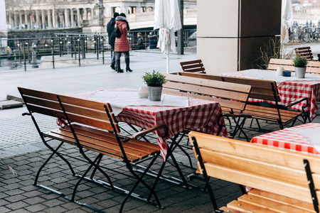 Empty street cafe in winter in Berlin. Waiting for visitors or low tourist season.の写真素材