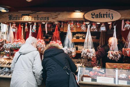 Berlin, December 25, 2017: People choose Christmas gifts at the traditional decorated Christmas market in Berlin, Germany.のeditorial素材