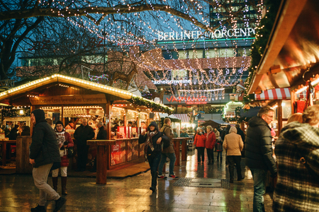 Berlin, December 25, 2017: Christmas market in Berlin in the evening. People choose Christmas gifts.のeditorial素材
