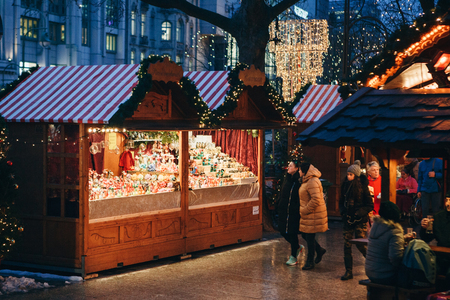 Berlin, December 25, 2017: Christmas market in Berlin in the evening. People choose Christmas gifts.のeditorial素材