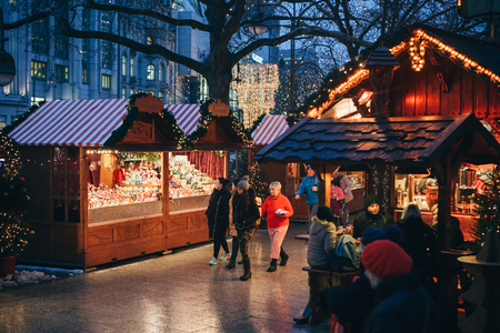 Berlin, December 25, 2017: Christmas market in Berlin in the evening. People choose Christmas gifts.のeditorial素材