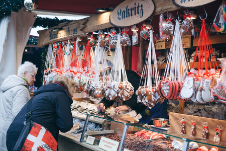 Berlin, December 25, 2017: People choose Christmas gifts at the traditional decorated Christmas market in Berlin, Germany.のeditorial素材