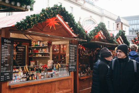 Berlin, December 25, 2017: People choose Christmas gifts at the traditional decorated Christmas market in Berlin, Germany.のeditorial素材