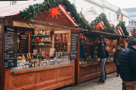 Berlin, December 25, 2017: People choose Christmas gifts at the traditional decorated Christmas market in Berlin, Germany.のeditorial素材