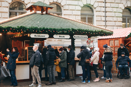 Berlin, December 25, 2017: People choose Christmas gifts at the traditional decorated Christmas market in Berlin, Germany.のeditorial素材