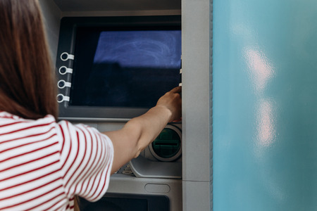 The tourist withdraws money from the ATM for further travel.の写真素材