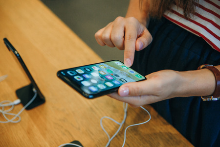 Berlin, August 29, 2018: The buyer looks to buy a new modern iPhone X in the official Apple store in Berlin in Germany.のeditorial素材