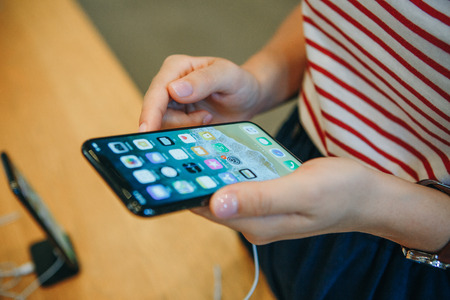 Berlin, August 29, 2018: The buyer looks to buy a new modern iPhone X in the official Apple store in Berlin in Germany.のeditorial素材