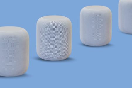 Wireless speakers for listening to music in a row on a blue background. Modern technologies.の写真素材