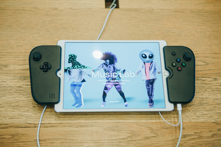 Berlin, August 29, 2018: Tablet ipad with special joysticks which turns into a console.のeditorial素材