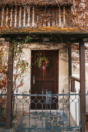 Traditional Christmas wreath on the door of a residential building. Tradition or celebration of Christmas.の写真素材