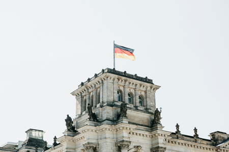 German flag over the Reichstag building in Berlin in Germany.の写真素材