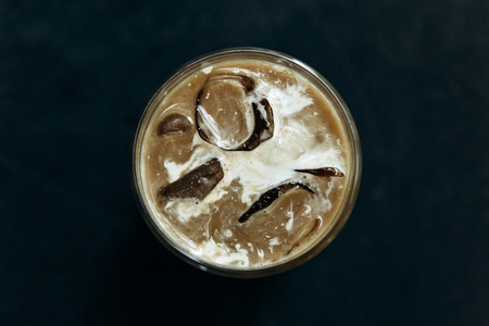 Top view close-up on aromatic fresh iced coffee on a dark background. Morning refreshing soft drink.の写真素材