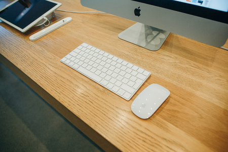 Berlin, August 29, 2018 Products of the company Apple. IMac, keyboard and computer mouse on the table. Not far lies the tablet of the same company. Products are presented in the official Apple Storeのeditorial素材