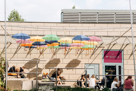 Germany, Leipzig, September 6, 2018: Creative cafe in Leipzig. Lots of colorful umbrellas hang...