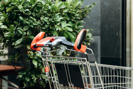 A shopping trolley at the entrance to the store is waiting for the buyer to approach.の写真素材