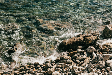 Beautiful view of the sea and the waves and the stone coast.の写真素材