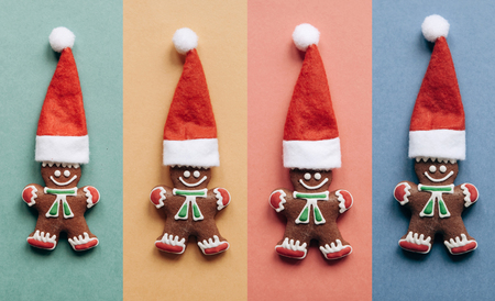 Set of Christmas gingerbread in the form of little ginger men in a red hat on colorful backgrounds....