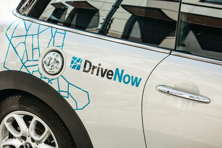 Germany, Berlin, September 05, 2018: Close-up on a company sign on a BMW electric car for the rental from a company called DriveNow. Car rental takes place through a mobile application.のeditorial素材