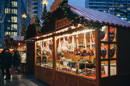 Berlin, December 25, 2017: Selling sweets and traditional gingerbread in the evening at the Christmas market in Berlin. Decorated stall.のeditorial素材